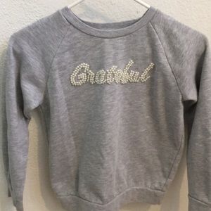 A long sleeve grey Shirt with pearls.